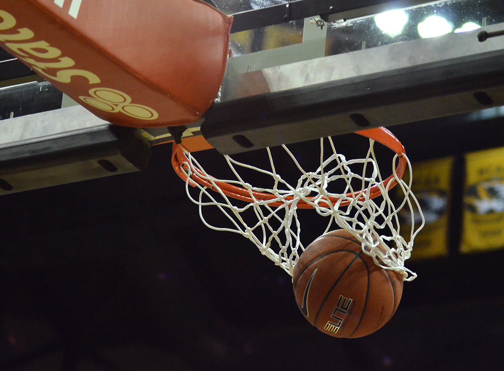 The ball falls through the net near the end of the fourth quarter